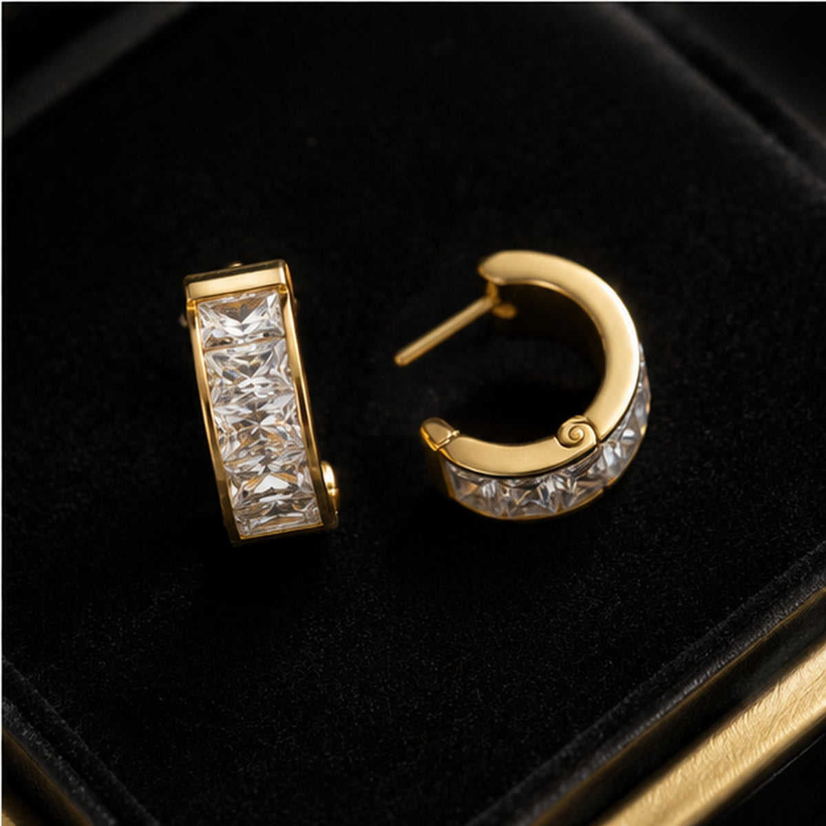 Close-up detail of gold-tone crystal huggie earrings