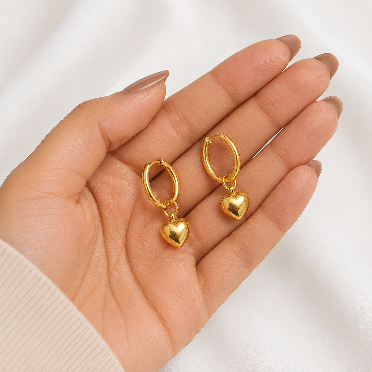 PRISA Gold Heart Hoop Drop Earrings held in hand