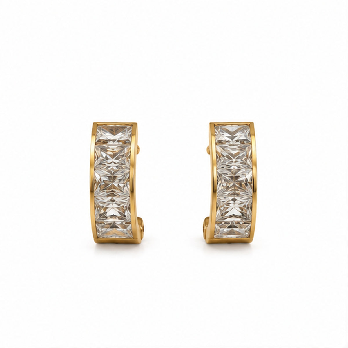 Gold-tone crystal huggie earrings on a plain white background