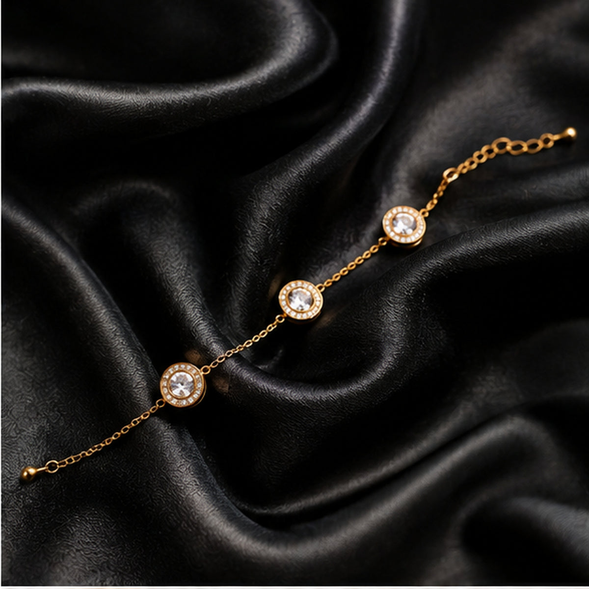 Dainty gold-tone crystal bracelet on black satin