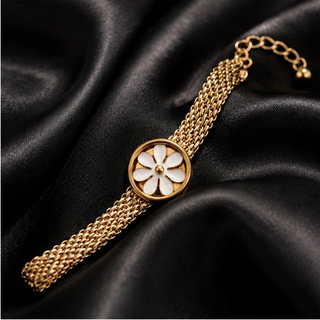 Gold-tone daisy mesh bracelet on black satin