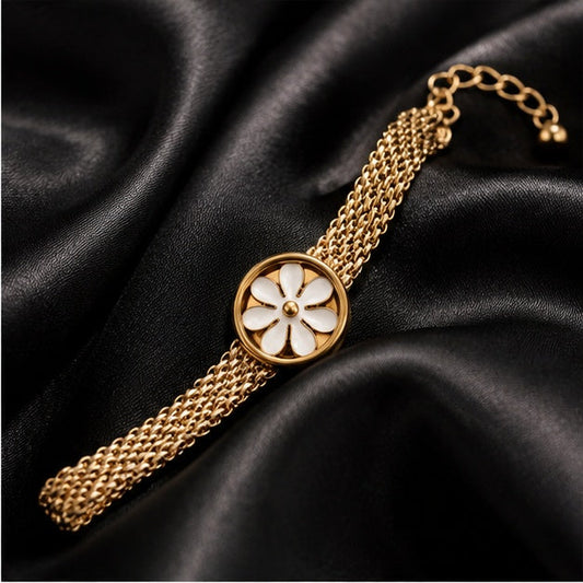 Gold-tone daisy mesh bracelet on black satin