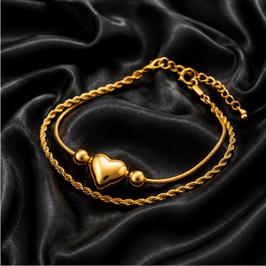 Gold heart bracelet on black satin