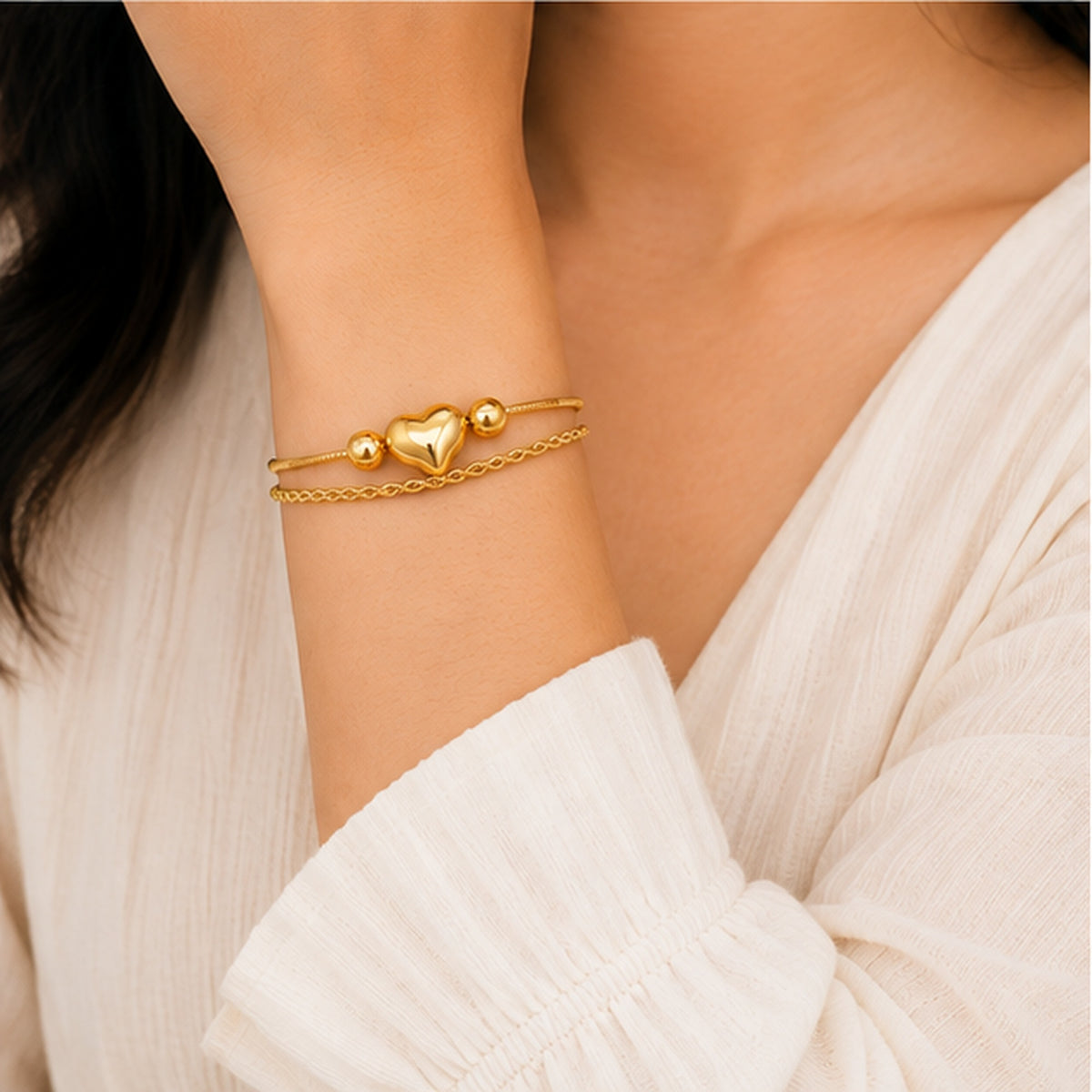 Woman wearing gold heart bracelet