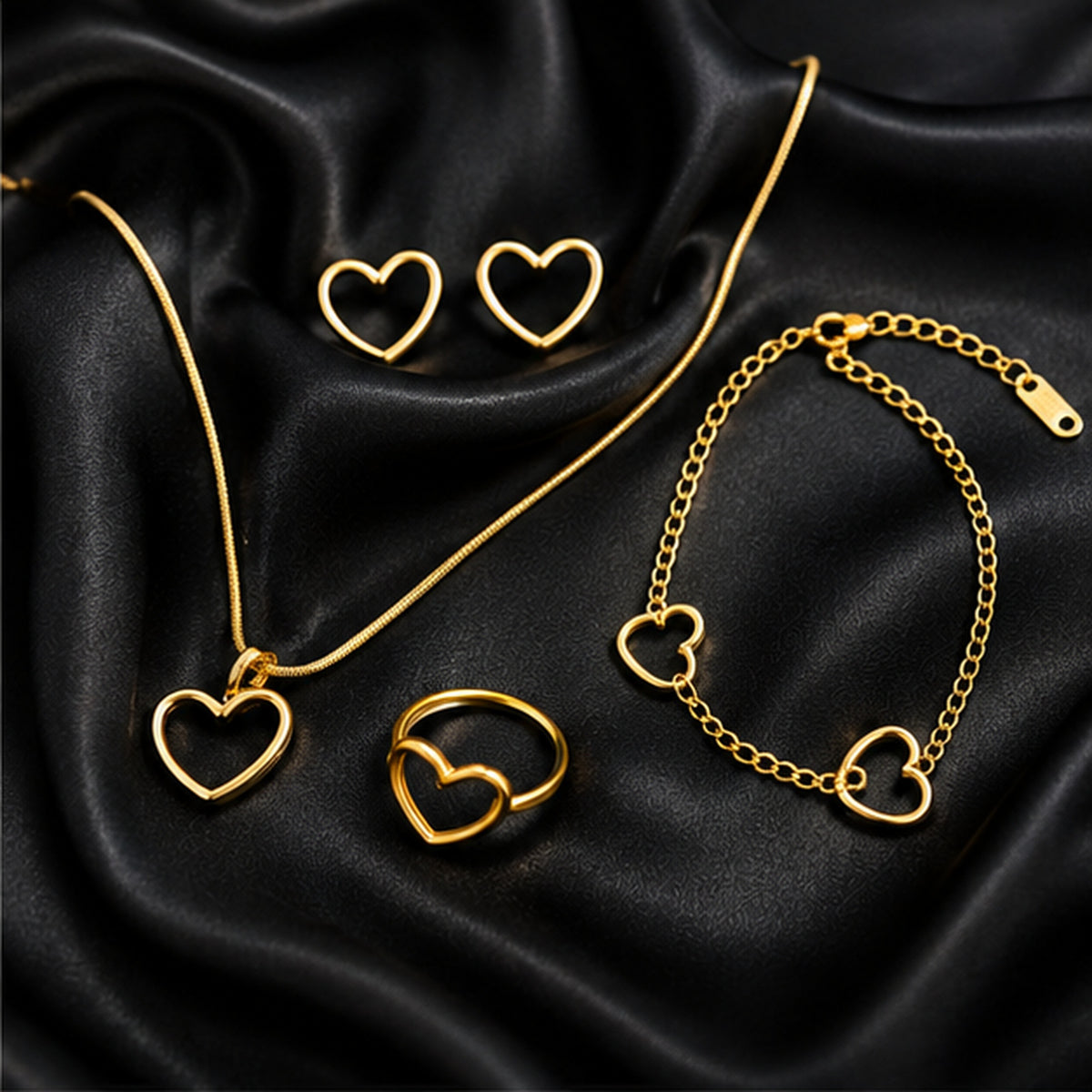 Gold heart jewellery combo on black satin