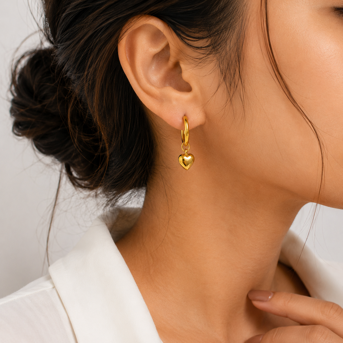 PRISA Gold Heart Hoop Drop Earrings worn by a woman