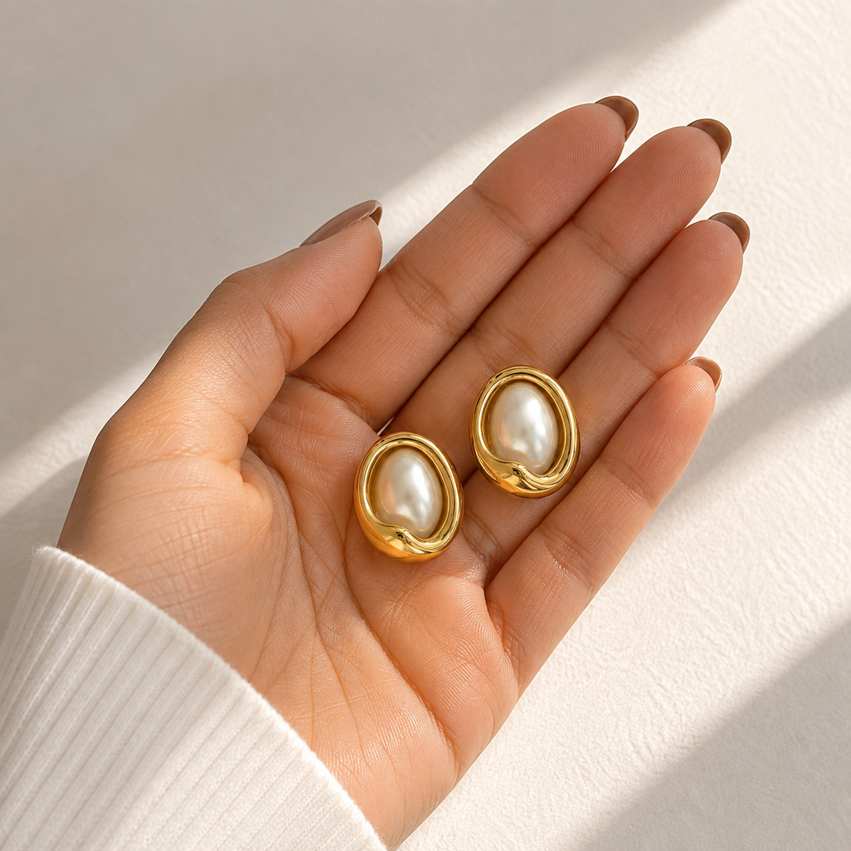 PRISA Gold Pearl Statement Stud Earrings held in hand