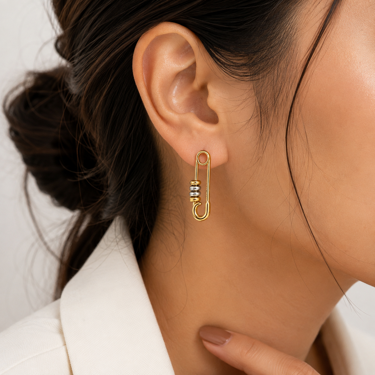 PRISA Gold Safety Pin Statement Earrings worn by a woman
