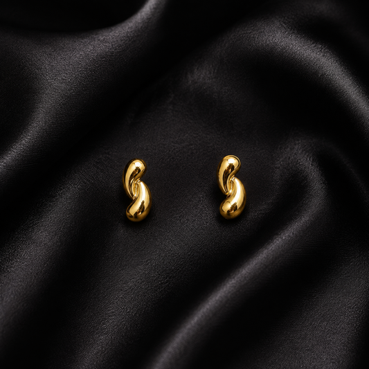 PRISA Gold Twisted Knot Stud Earrings on black satin