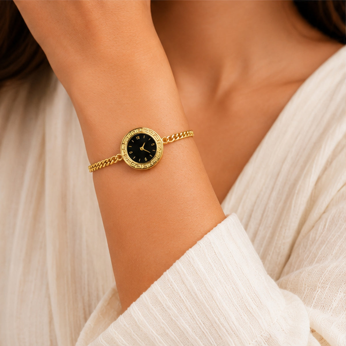 Woman wearing gold watch-style bracelet